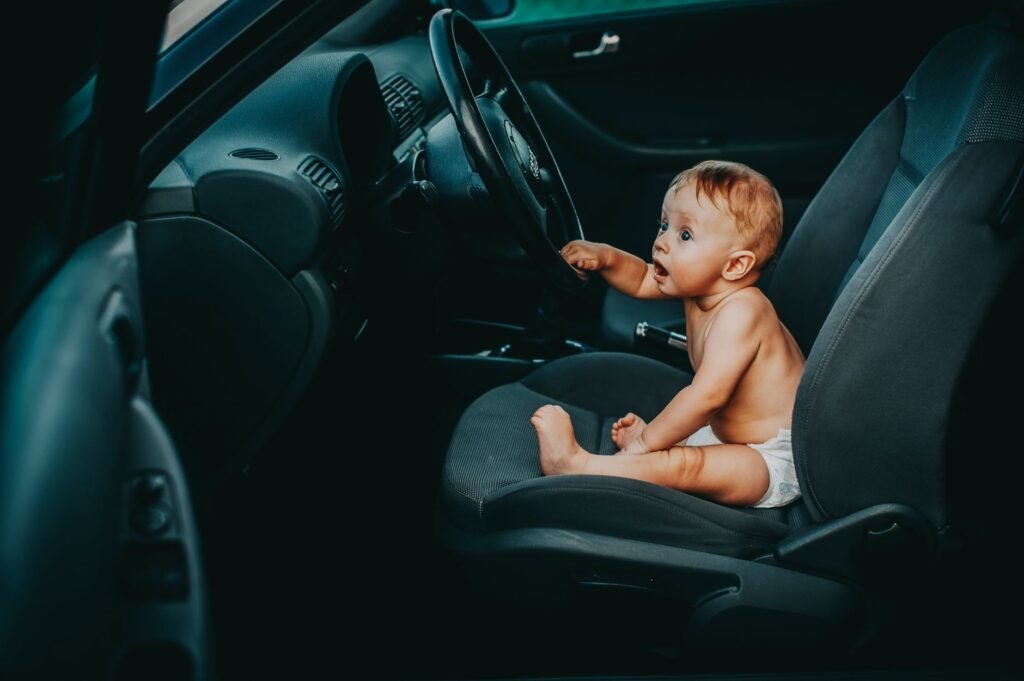 A baby buckled safely into a rear-facing car seat