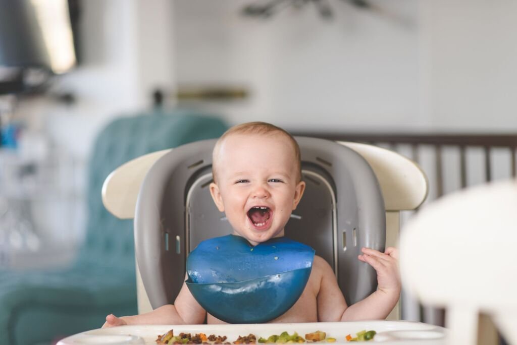 A baby trying solid food for the first time, exploring new flavors