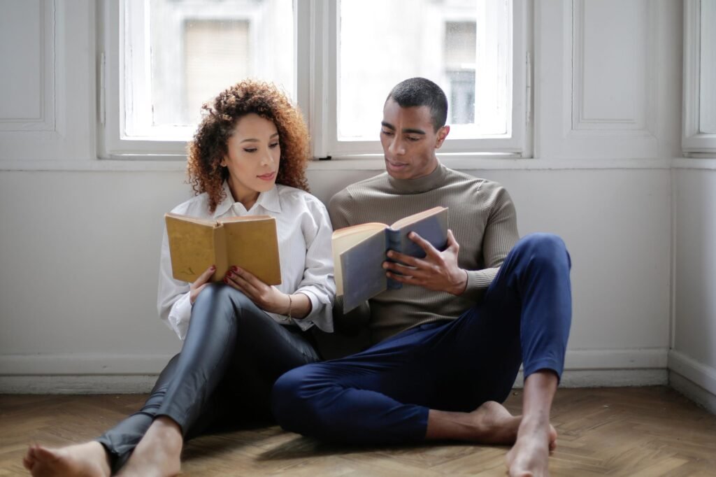 A couple researching together on a sofa