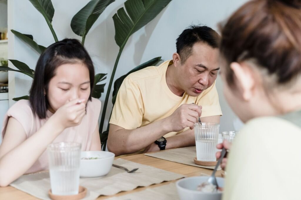 A family enjoying a meal together, encouraging a nurturing eating environment
