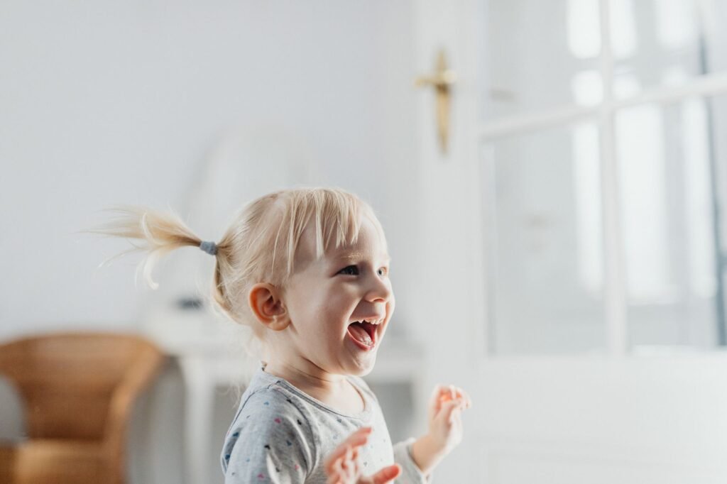 A happy toddler smiling at the camera