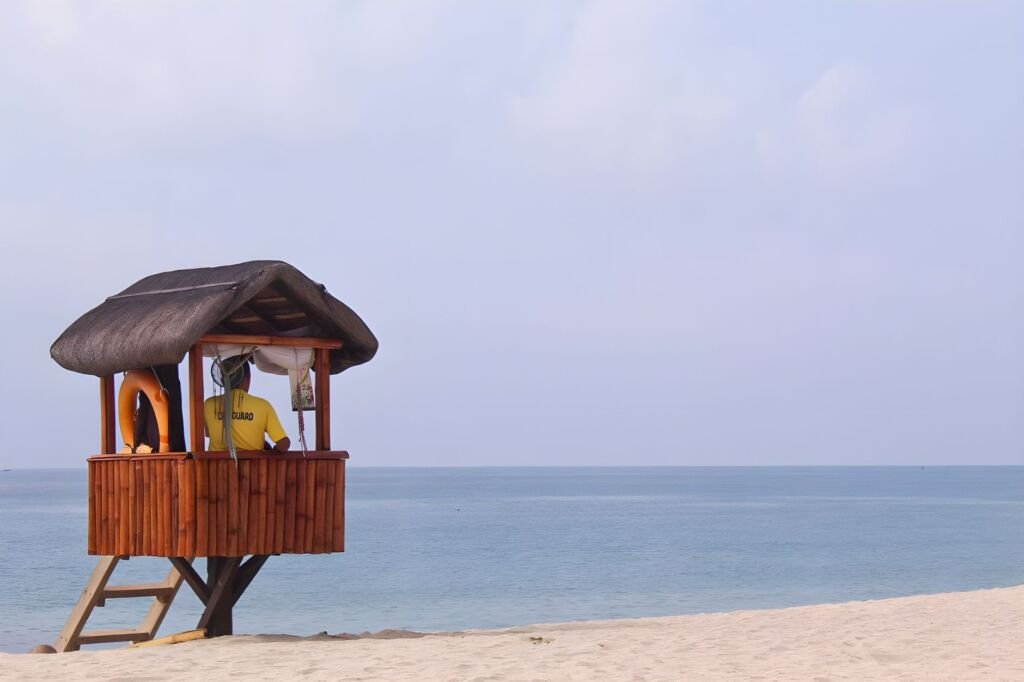 A lifeguard monitoring beachgoers to ensure safety in the water
