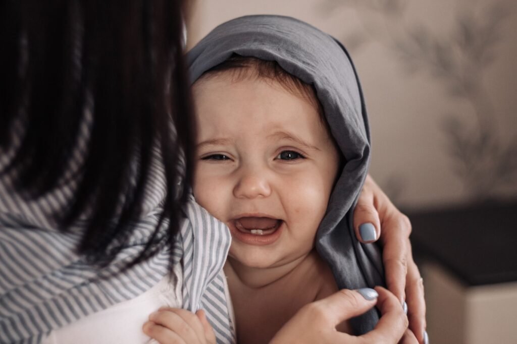 A loving parent soothing their teething baby with gentle hugs