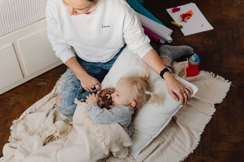A mother comforting her toddler with a gentle hug