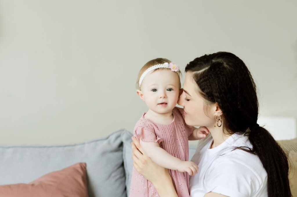 A mother gently holding her baby daughter