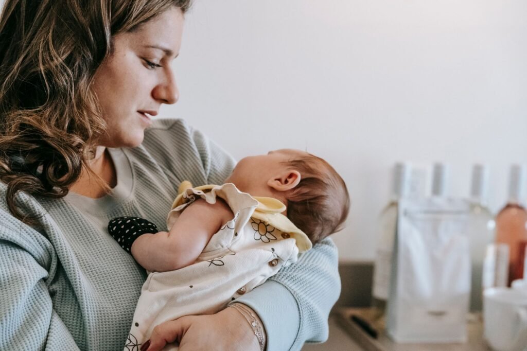 A new mother holding her newborn close after birth