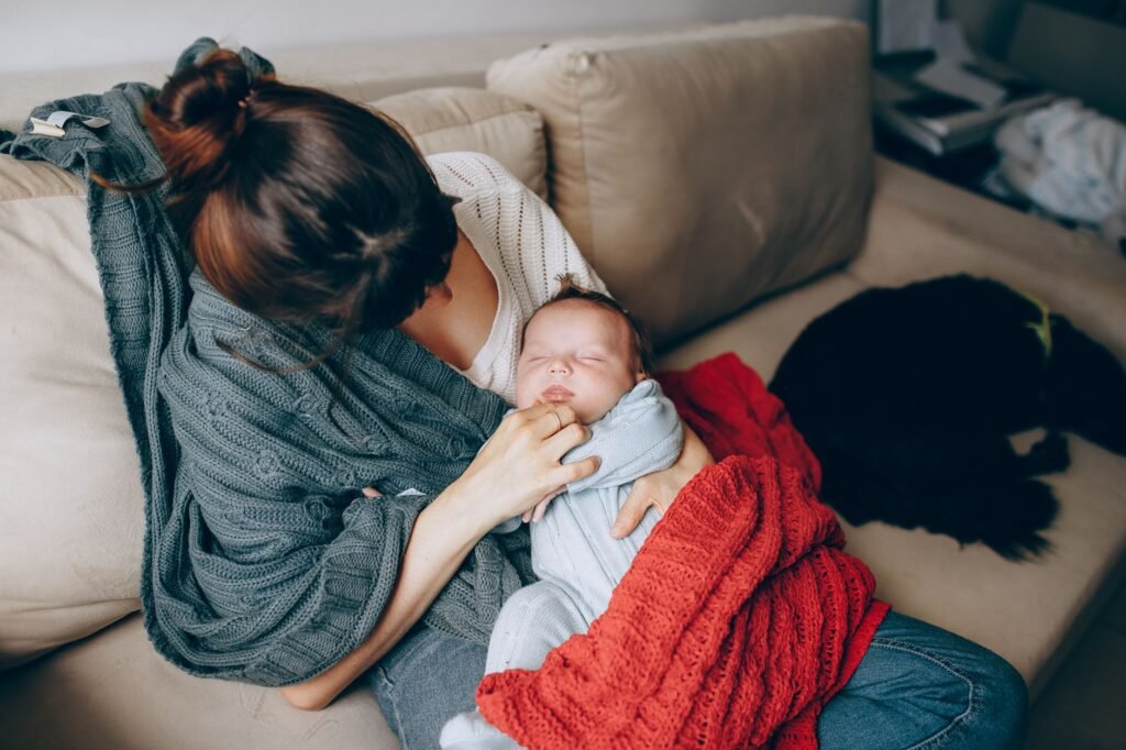 A new mother resting in bed with her newborn baby