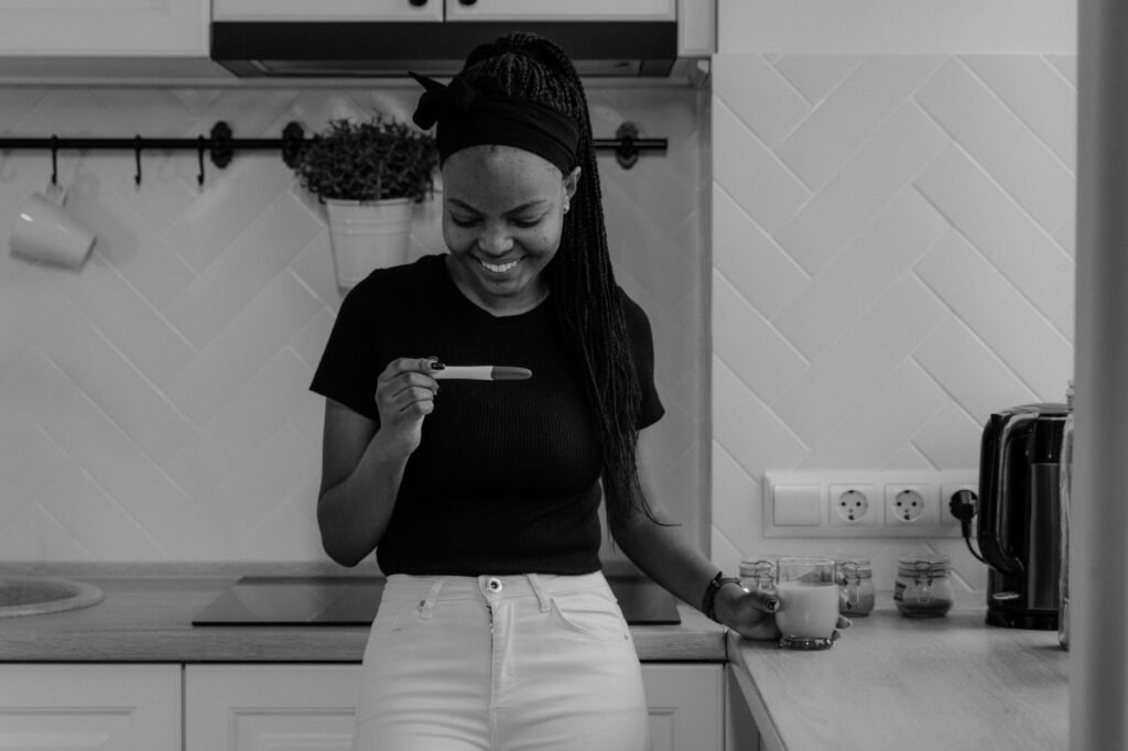 A newly pregnant woman smiling as she learns the happy news