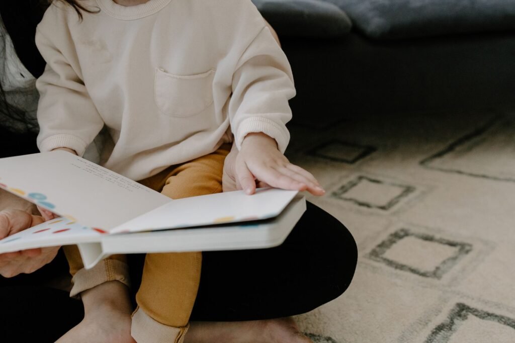A parent and toddler reading a picture book together