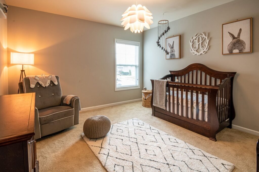 A simple nursery with a safe crib and a changing area covers most newborn needs