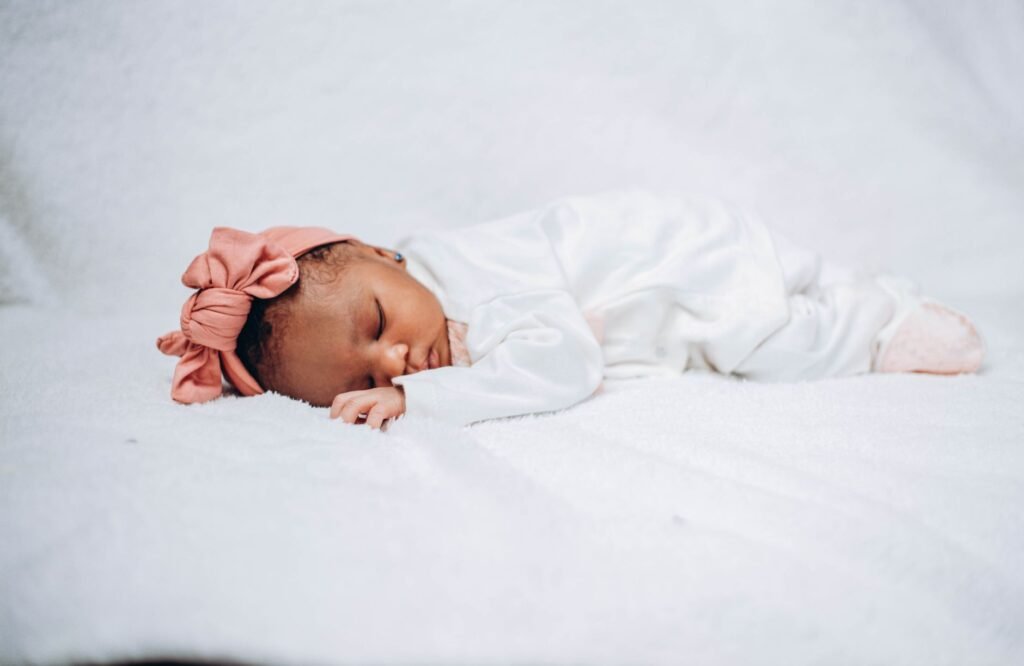 A sleeping baby girl wrapped in a soft blanket
