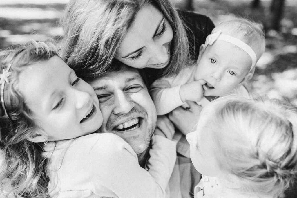 A smiling family sitting close together at home