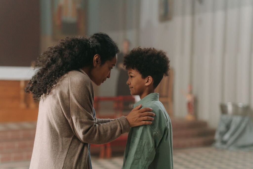 A supportive parent encouraging their shy child to engage with peers