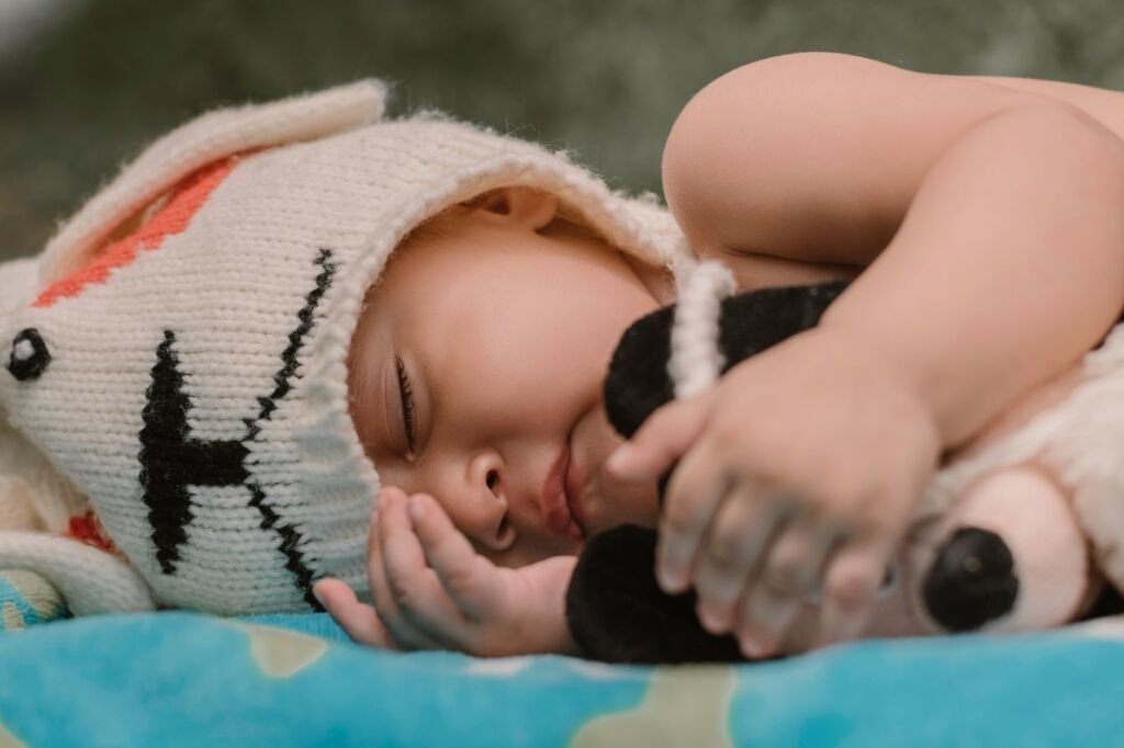 A tired baby cuddling with their favorite stuffed animal during bedtime