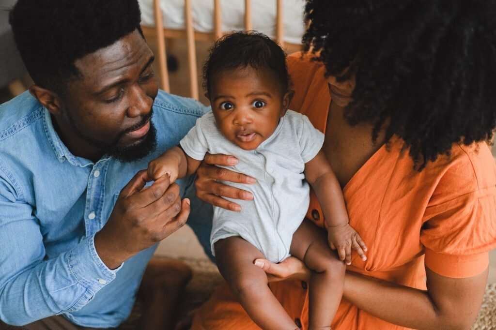 New parents relaxing together with their baby at home