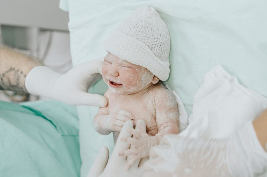 Newborn baby peacefully sleeping in a hospital crib