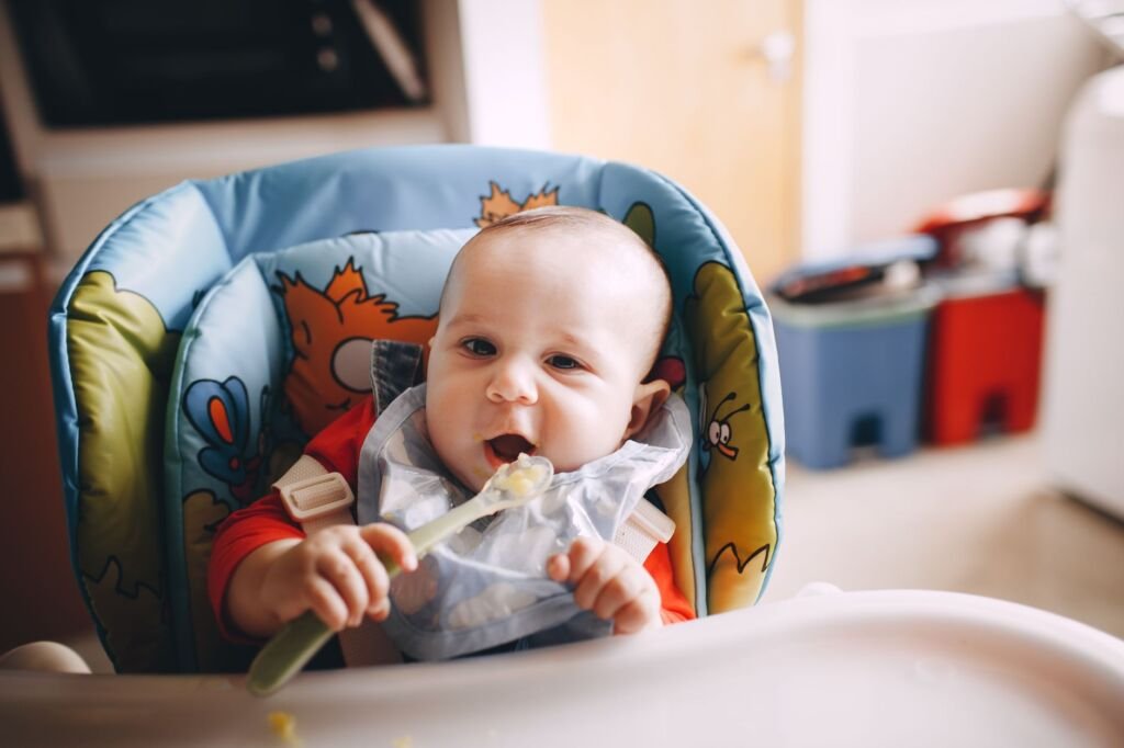 A baby happily exploring solid foods for the first time