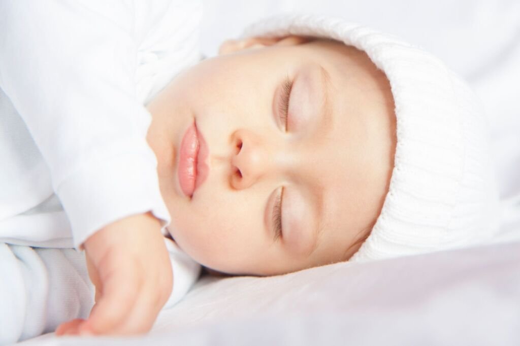 A baby sleeping peacefully in a cozy crib