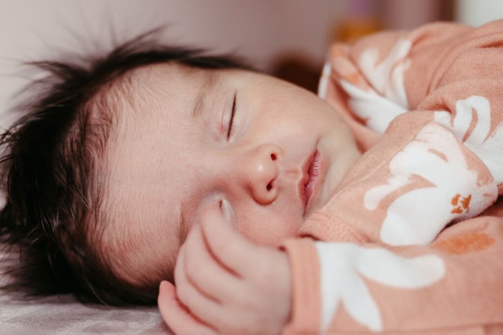 A baby sleeping peacefully in a crib with safety measures in place