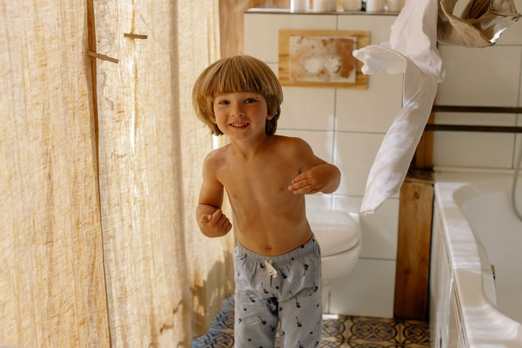 A child exploring the bathroom environment to become familiar with potty training