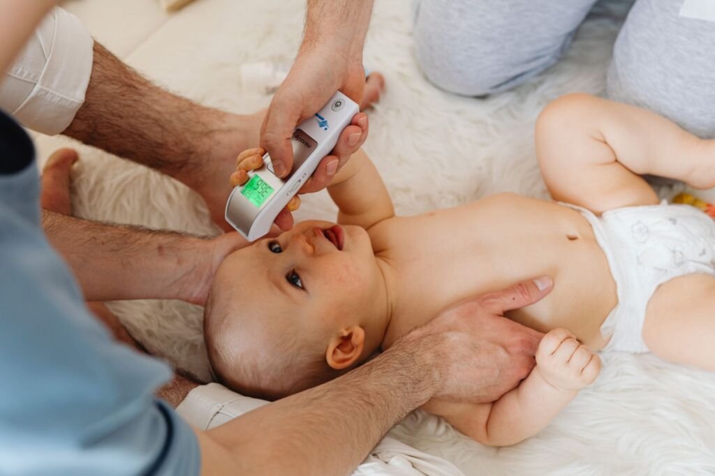A family checks their baby monitor while resting in the living room