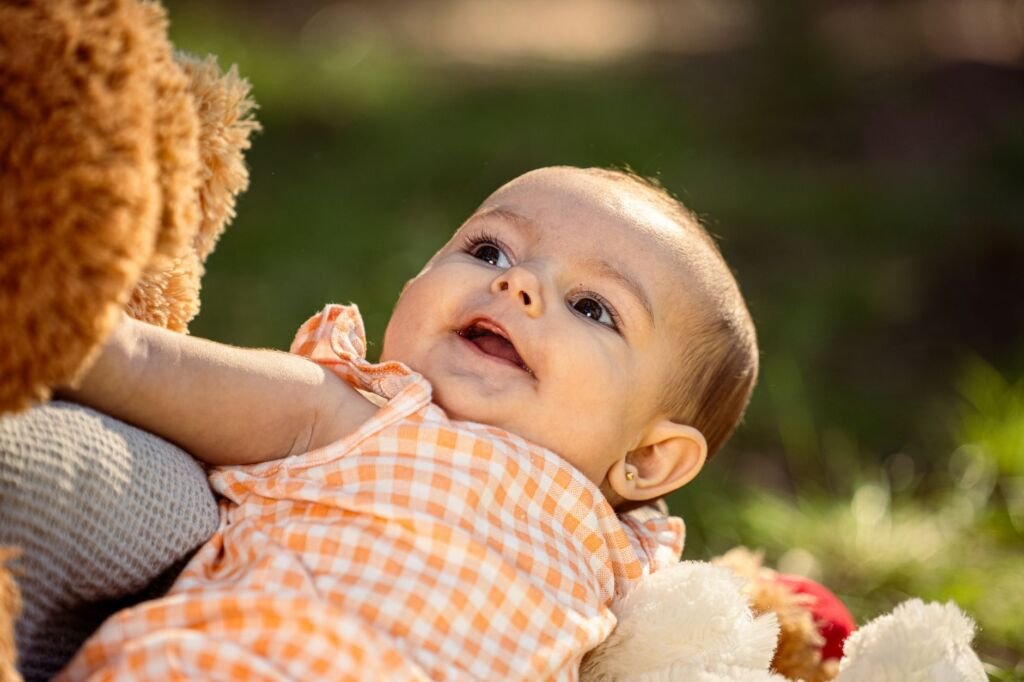 A joyful baby girl smiles, embodying the beauty of unique names