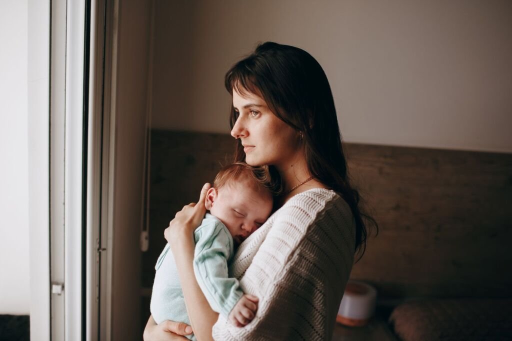 A mother lovingly holding her newborn baby after delivery