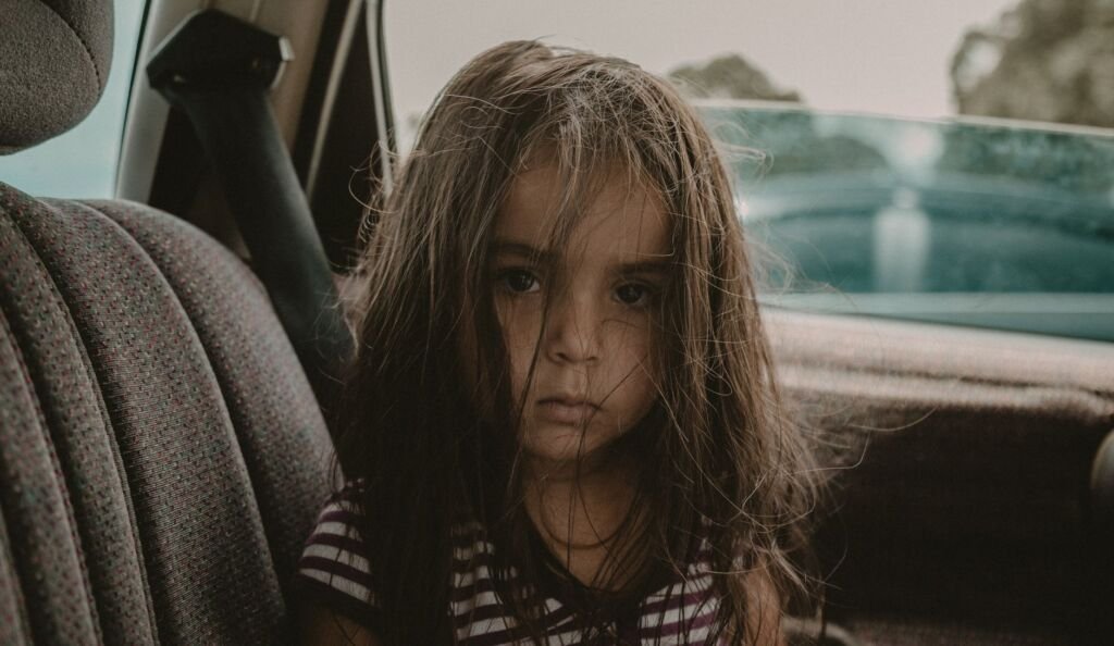 A snugly secured child in a car seat, illustrating safety