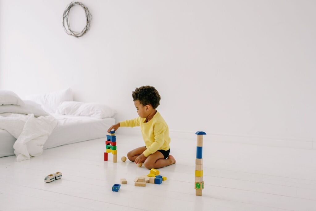 A toddler enthusiastically stacks colorful blocks during playtime