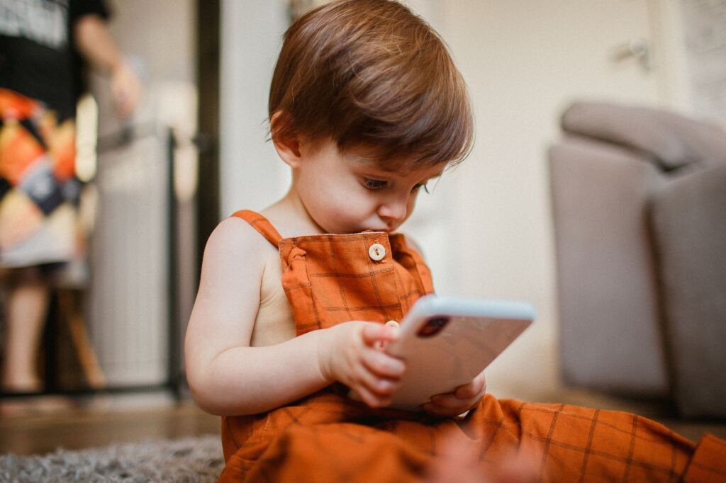 A young child confidently using a potty chair