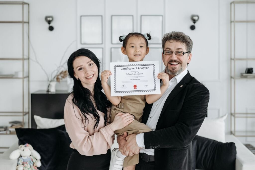 Adoptive parents sharing a tender moment with their child