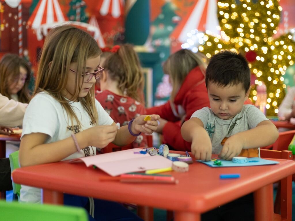 Children excitedly work on their holiday decorations