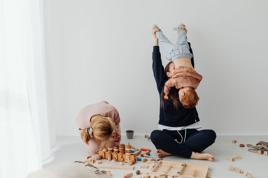 Family enjoying playful moments with children in a cozy indoor setting