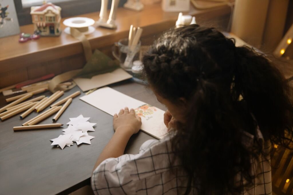 Kids express their creativity while designing Christmas cards for loved ones