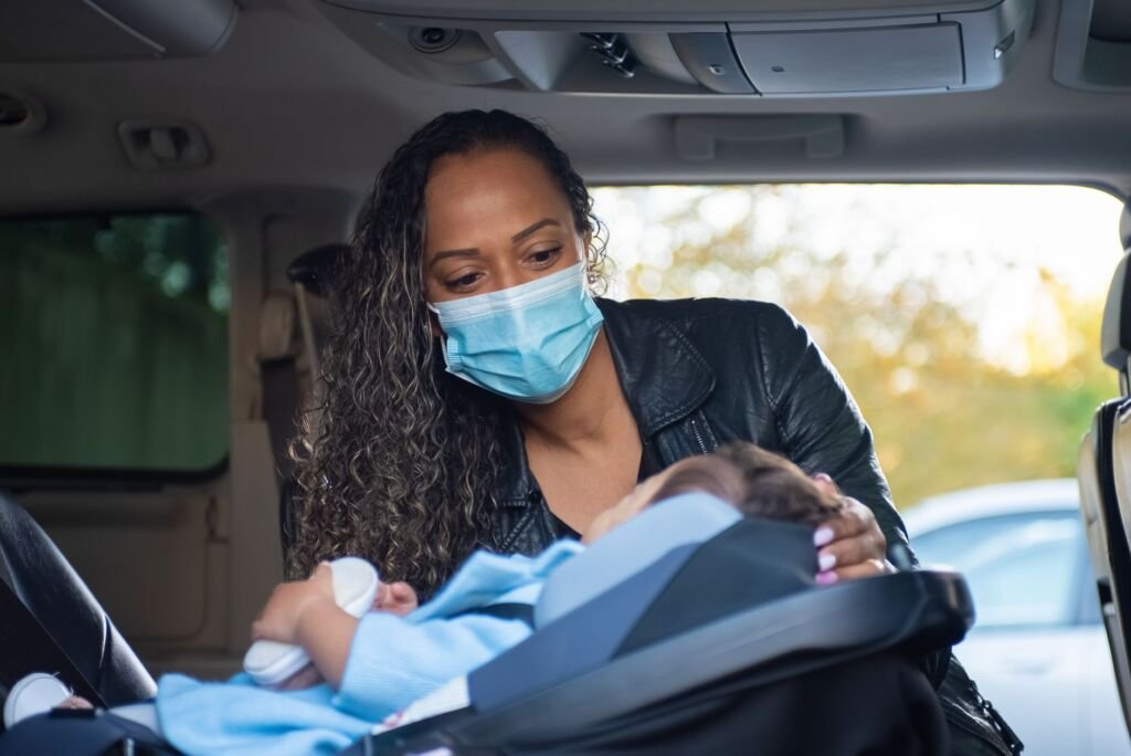 Parents carefully installing a convertible car seat in their vehicle for maximum safety