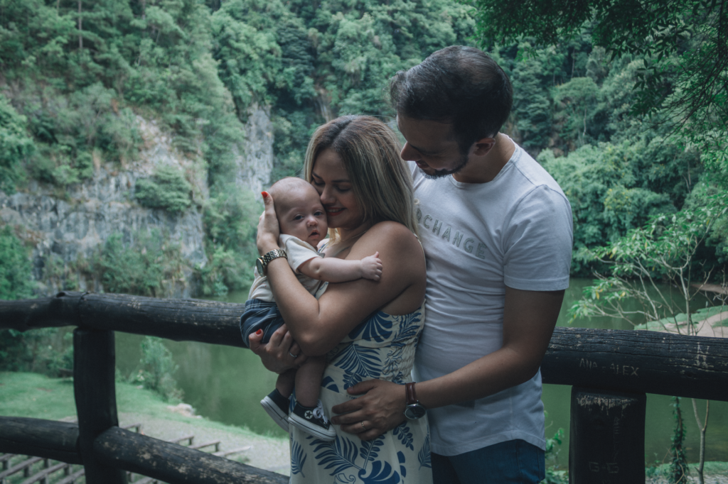 Parents enjoying a moment outdoors with their baby