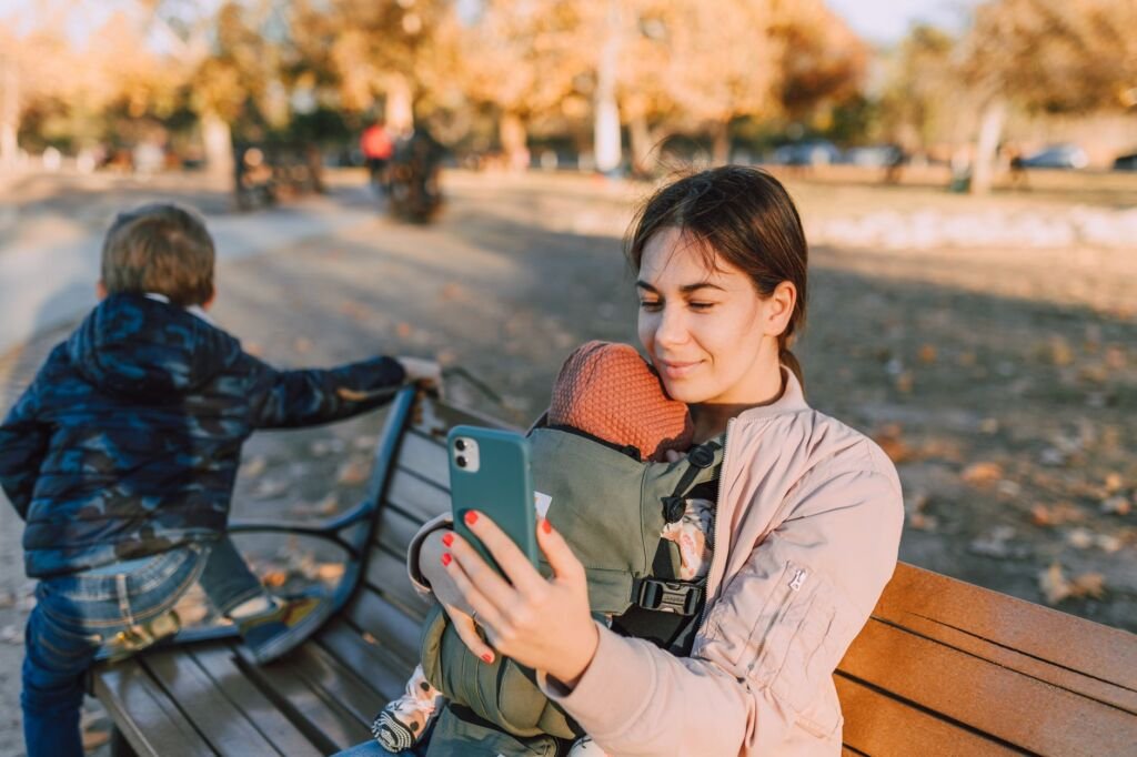 Parents joyfully using a baby carrier during an outing