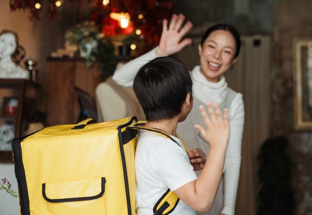 Parents wave goodbye as their child enters the school on the first day